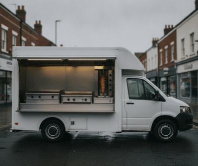 White long-wheelbase kebab and grill van with an open side serving hatch on a UK town-centre street
