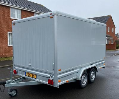 Grey catering trailer on a damp UK driveway with condensation on the roof