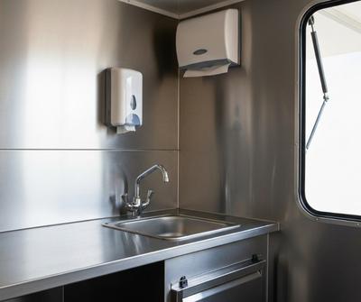 Stainless steel hand wash basin inside a UK mobile catering trailer