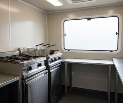 Inside a British burger van fit-out with stainless steel gas cooking equipment