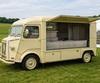A vintage Citroen HY van converted into a mobile catering unit at a country fete.