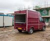 Burgundy catering van serving workers on a UK building site