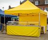 Yellow catering gazebo and market stall at a UK outdoor food market