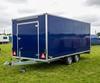 Navy blue twin-axle catering trailer parked at a UK showground