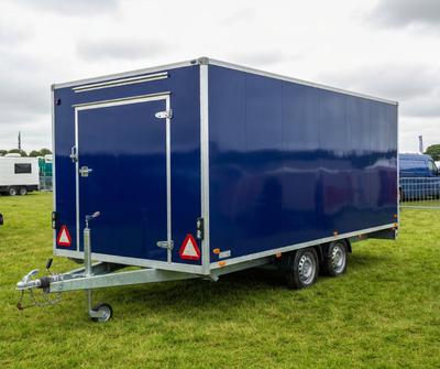 Navy blue twin-axle catering trailer parked at a UK showground