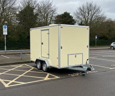Cream box catering trailer parked in a UK council car park