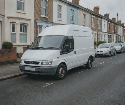 White burger van parked at the kerb on a UK residential street