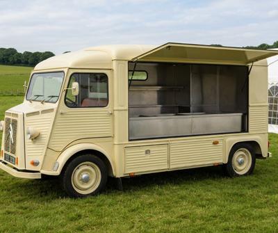 A vintage Citroen HY van converted into a mobile catering unit at a country fete.
