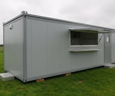 Grey portacabin catering cabin on private grassland in the UK