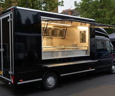 Black kebab van serving customers at a UK event