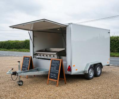 Burger catering trailer with serving hatch open in a UK layby